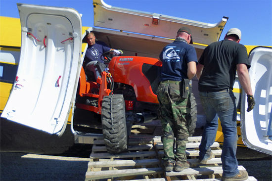 New Kubota tractor exits the big Yellow Bird. New Kubota tractor exits the big Yellow Bird.